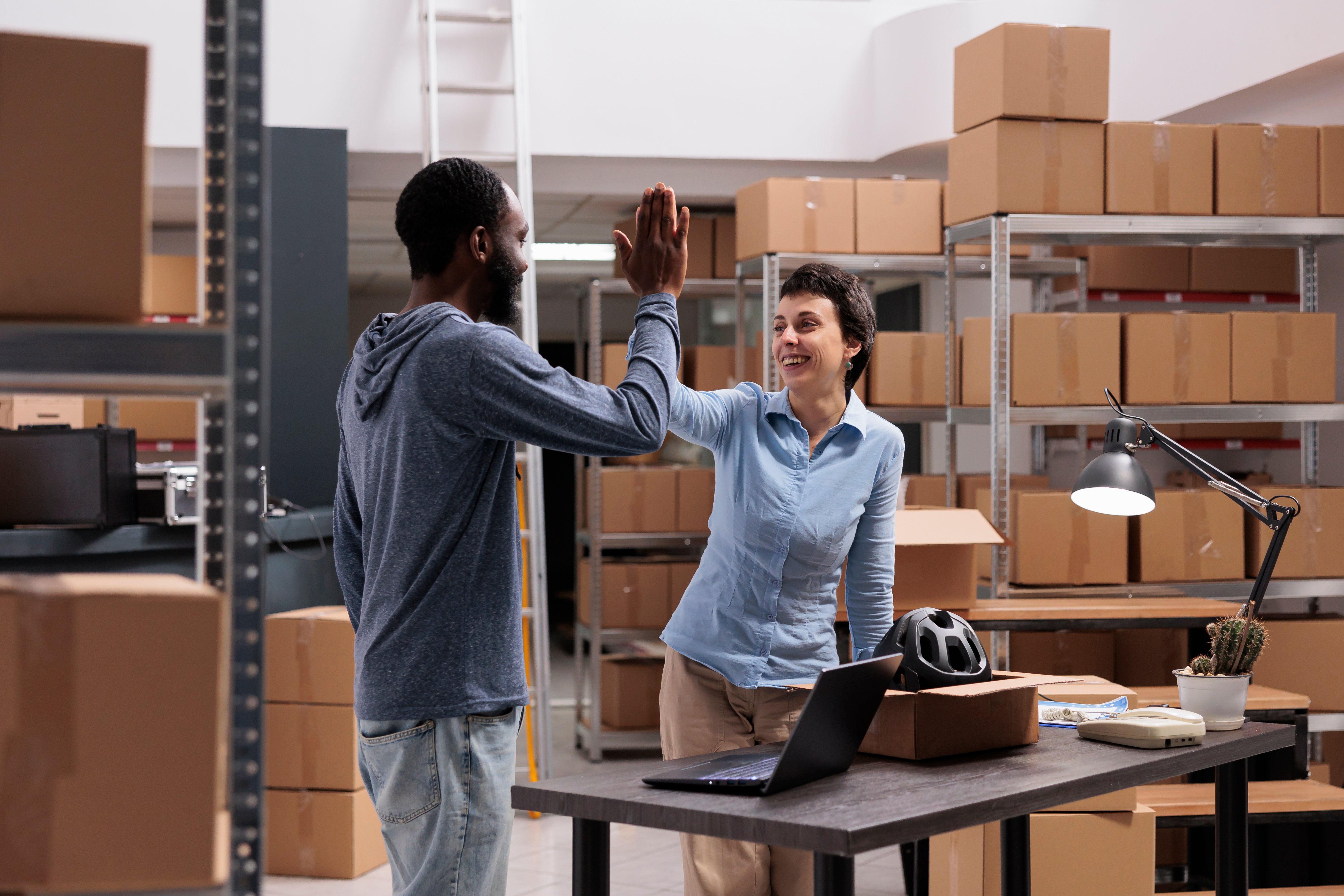 happy-storehouse-employees-doing-high-five-after-f-2025-02-17-17-03-30-utc